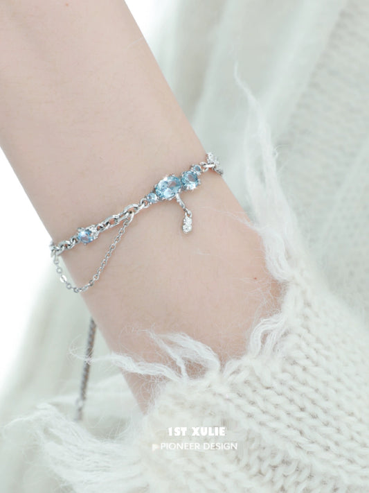 Elegant 1ST XULIE blue moonstone bracelet with silver accents, showcasing shimmering gemstones on a delicate chain