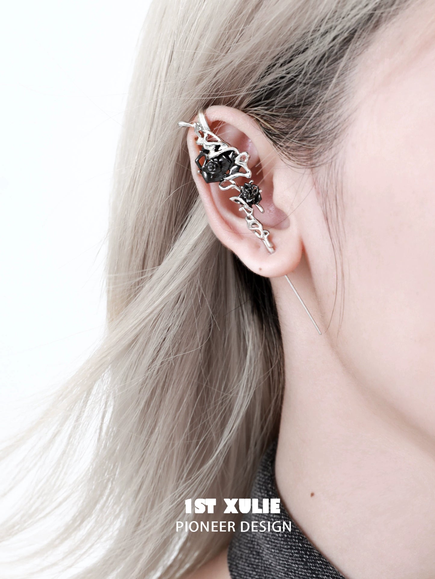 Forbidden rose ear piercing needle alongside a stylish ear cuff on a person's ear