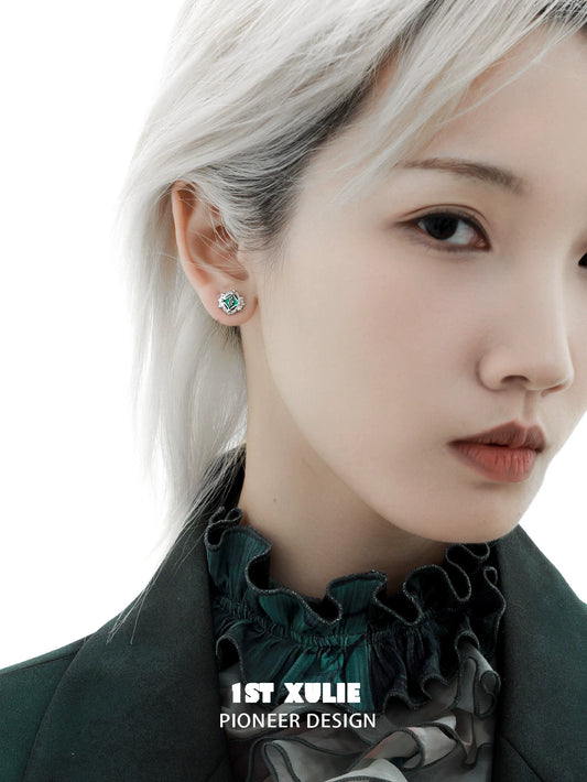 Model wearing green serpent ear cuffs featuring intricate design and elegant style