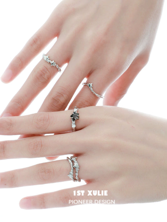 Elegant silver star couple ring set on hands showcasing intricate designs and sparkling stones