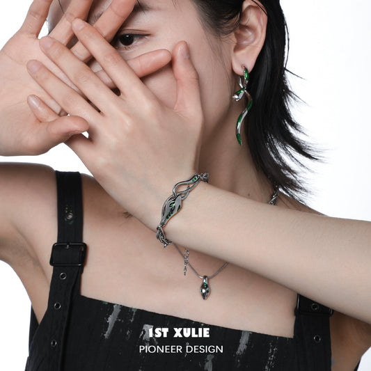 Slytherin snake bracelet featuring intricate design in green and silver, worn on a model's wrist