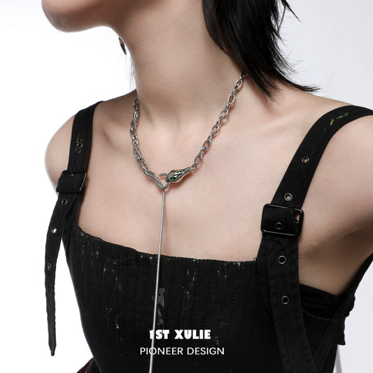 Slytherin snake necklace with a sleek design, worn by a model in a stylish outfit