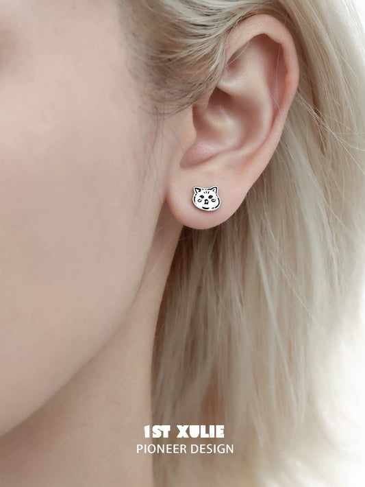 Cute street art cat earrings displayed on an ear, perfect for art lovers and unique jewelry enthusiasts