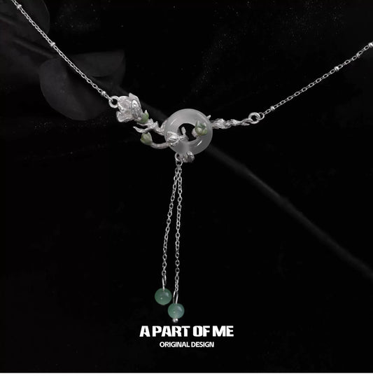 A delicate jasmine silver necklace featuring floral designs and adjustable chains for elegant styling