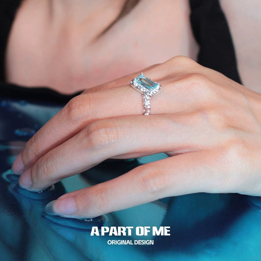 Elegant A PART OF ME mermaid tears silver ring with a sparkling blue gemstone, worn on a hand