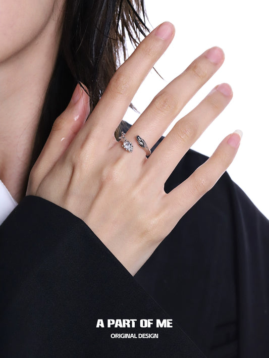 A woman's hand wearing a snake diamond silver ring showcasing intricate design and elegance