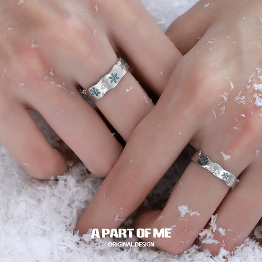A PART OF ME snowflake love ring displayed on hands amidst falling snow for a winter-inspired look