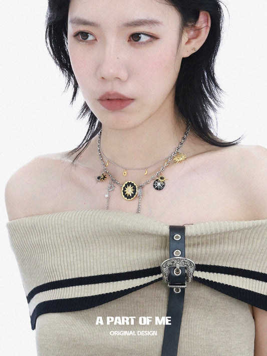 A PART OF ME sun and moon necklace featuring intricate designs with celestial charms