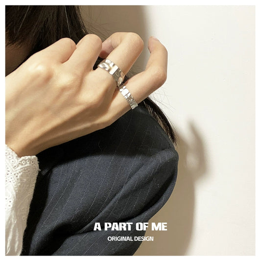 Stylish silver tinfoil crinkle punk ring worn on a hand with a black outfit