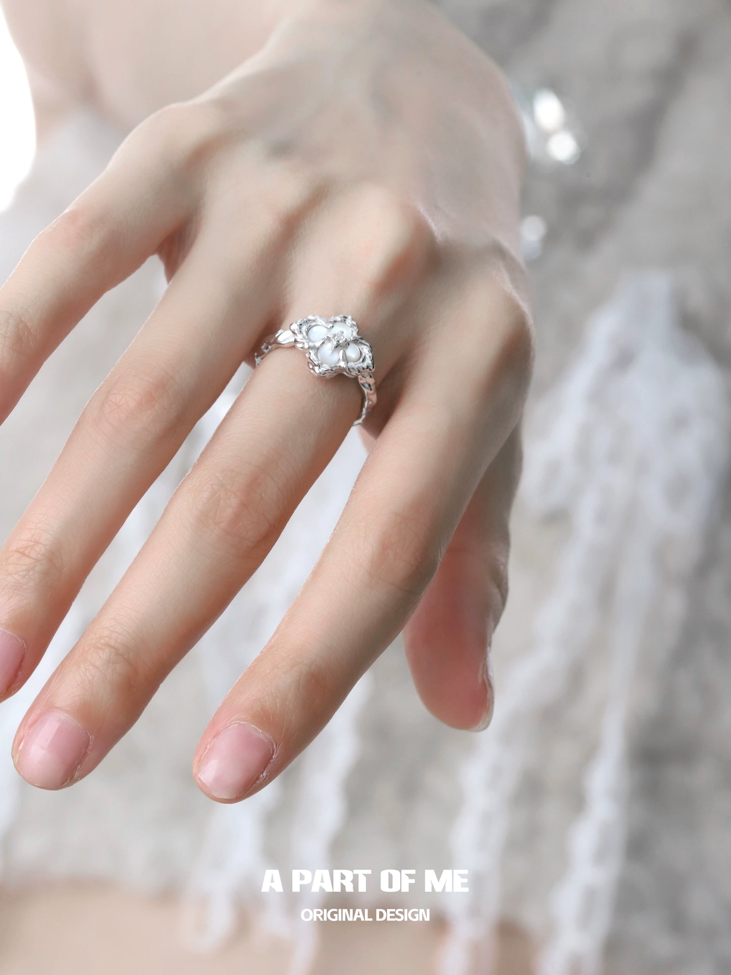 Elegant butterfly clover silver ring on a model's hand showcasing detailed design and craftsmanship