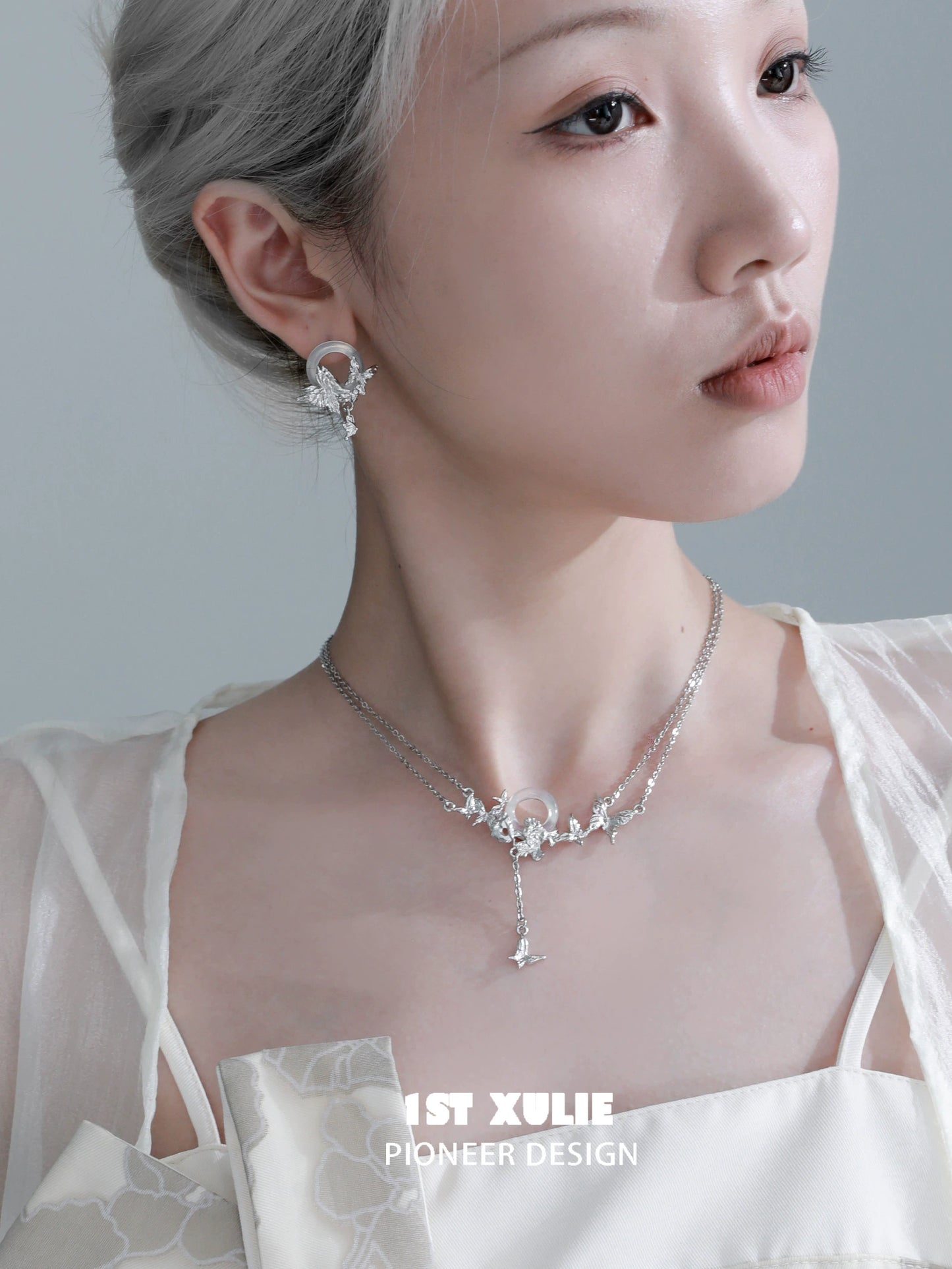 Elegant butterfly silver necklace from 1STXULIE displayed on a model showcasing its intricate design