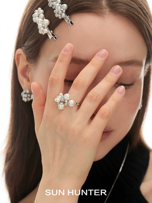 Elegant pearl statement ring worn by a woman showcasing a stylish look with pearl accessories