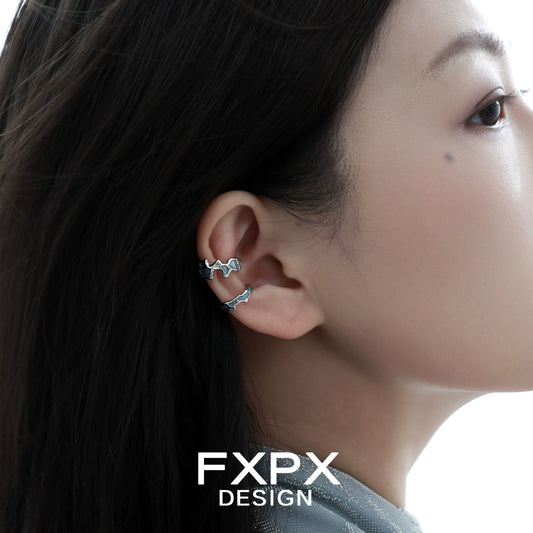 FXPX Mystic Island Ear Cuff displayed on a model's ear showcasing its unique design and stylish appeal