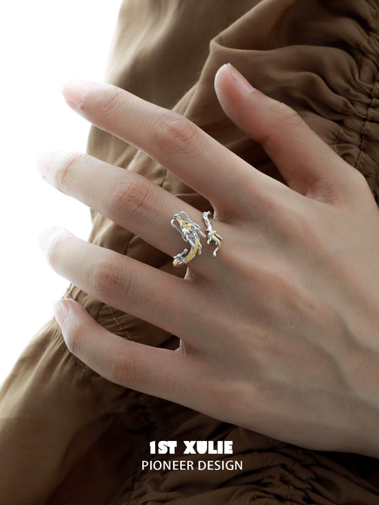 Gold dragon wrap silver ring on a model's hand, showcasing a unique and elegant design