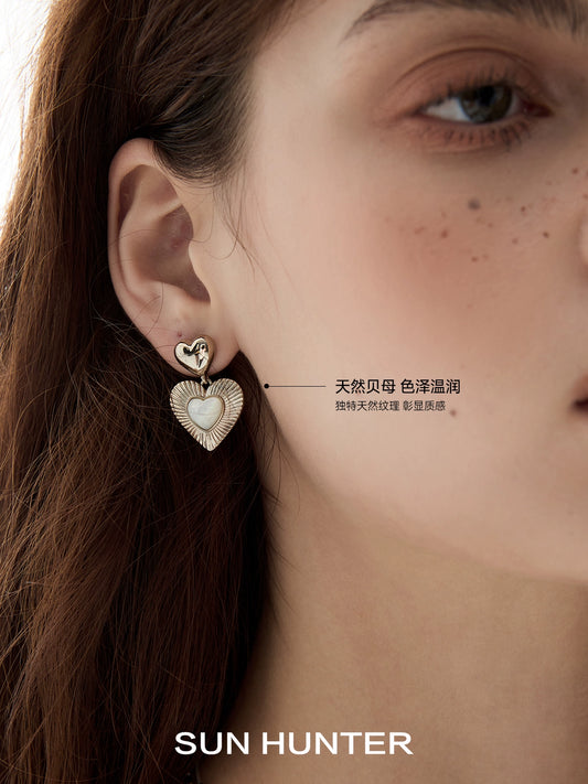 Stylish heart shaped statement earrings from SUN HUNTER featuring a unique design and elegant finish