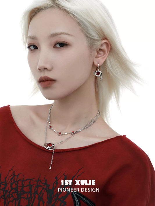 Mars inspired necklace from 1ST XULIE featuring a unique design with red accents and silver details