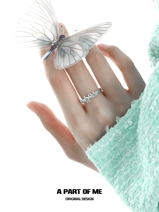 Elegant mint butterfly ring from A PART OF ME showcased on a hand with a delicate butterfly perched nearby