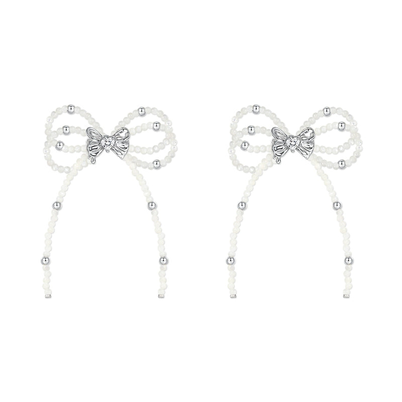 SUN HUNTER pearl bow ribbon earrings featuring elegant design with silver accents and delicate pearls