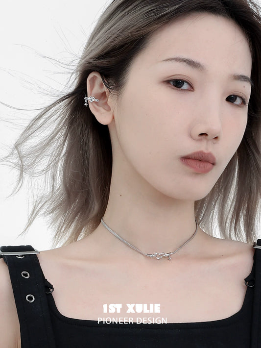 Punk heart necklace from 1STXULIE showcased on a model with layered silver chains