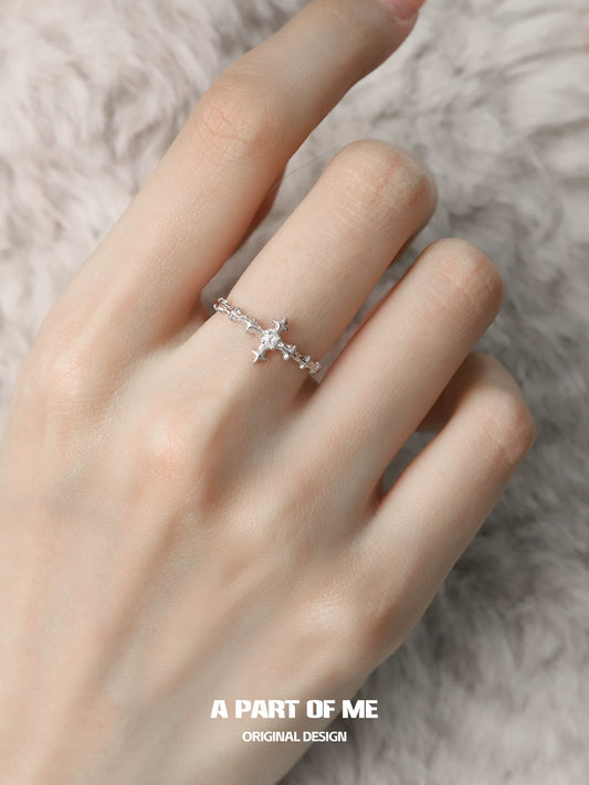 Delicate silver cross ring by A PART OF ME with intricate detailing on a model's hand