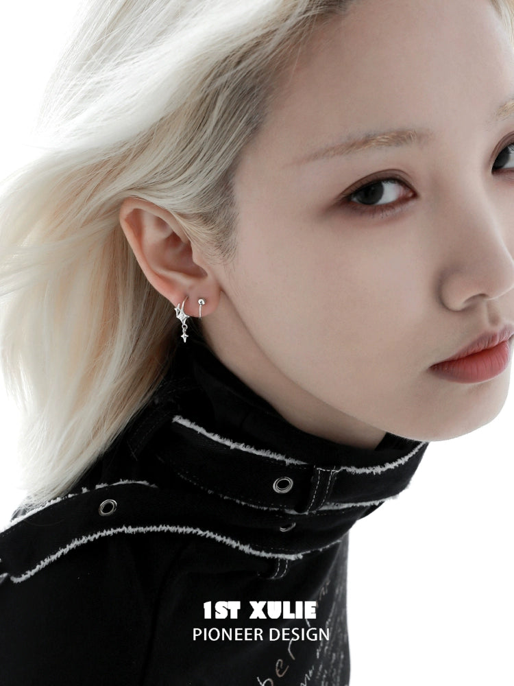Stylish silver star earrings showcased on a model with a chic hairstyle