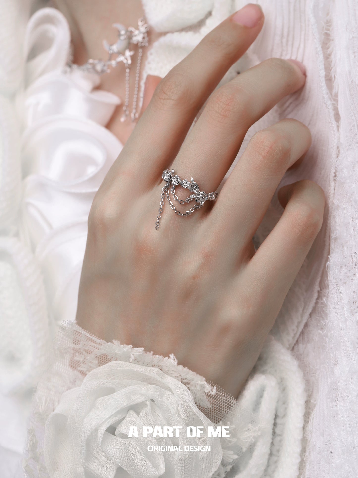 Elegant A PART OF ME snow rose chain ring worn on a hand with delicate accessories