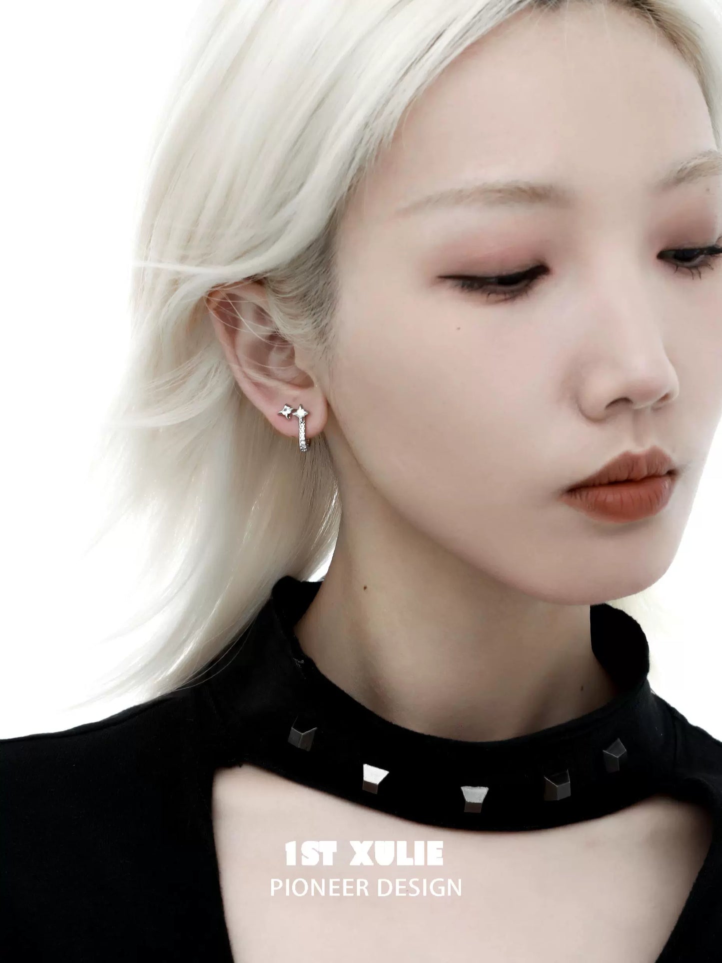 Model wearing star hoop silver earrings showcasing a modern and elegant design