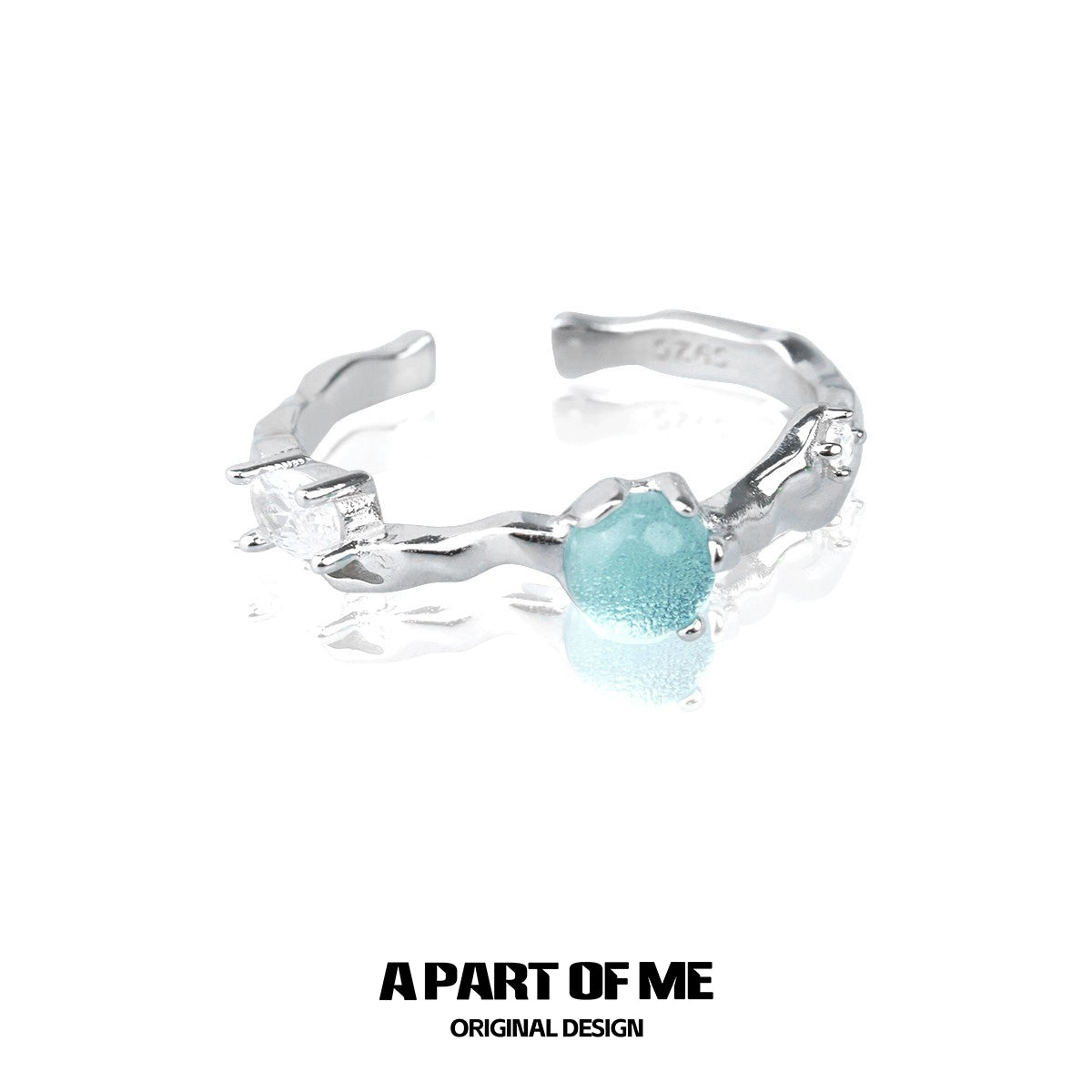 A PART OF ME silver statement ring featuring a blue gemstone centerpiece and sparkling accents
