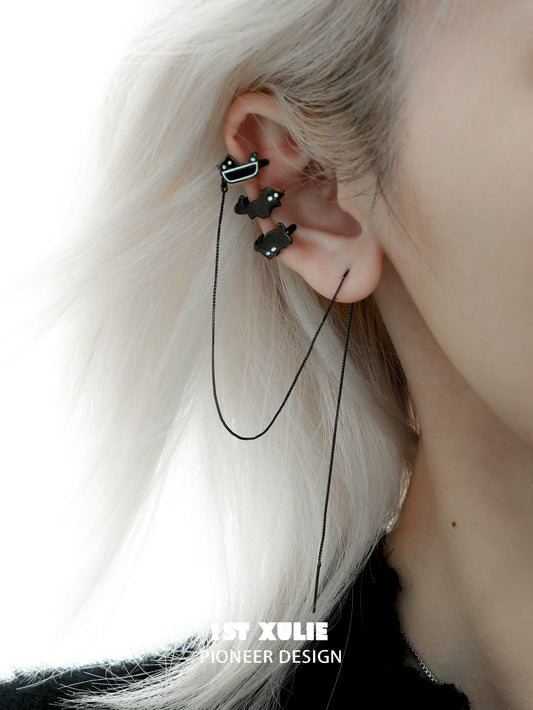 Y2K black cat ear cuffs with a sleek design, stylishly worn on a model's ear