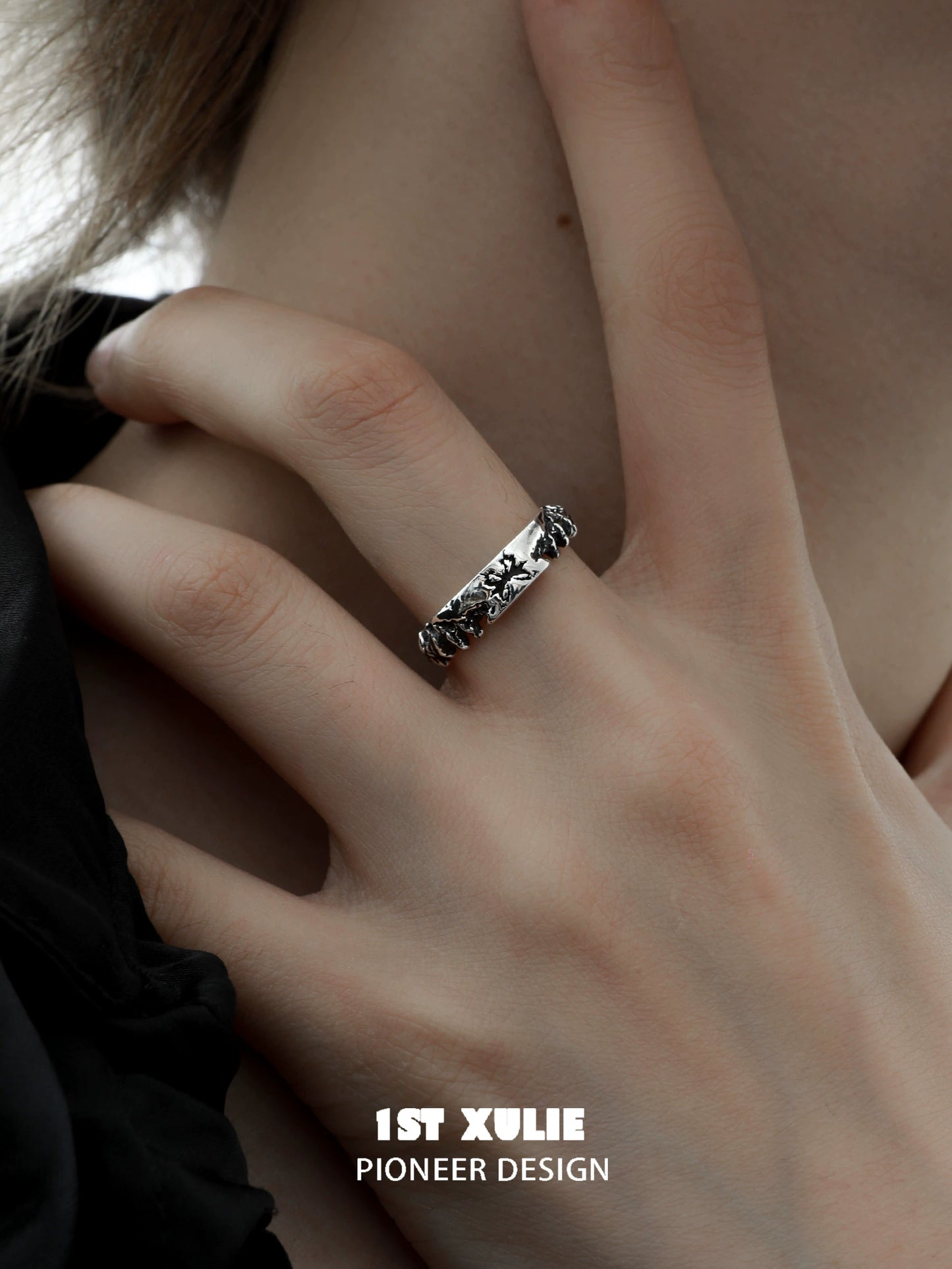 Y2K butterfly ring in silver worn on a hand with a stylish black outfit
