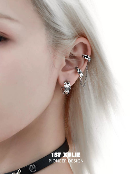 Y2K puppy chain earrings showcasing a unique design on a model's ear with silver detailing