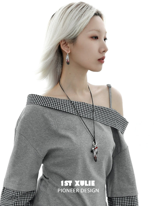 Y2K red feather earrings showcased on a model wearing a stylish gray off-shoulder top