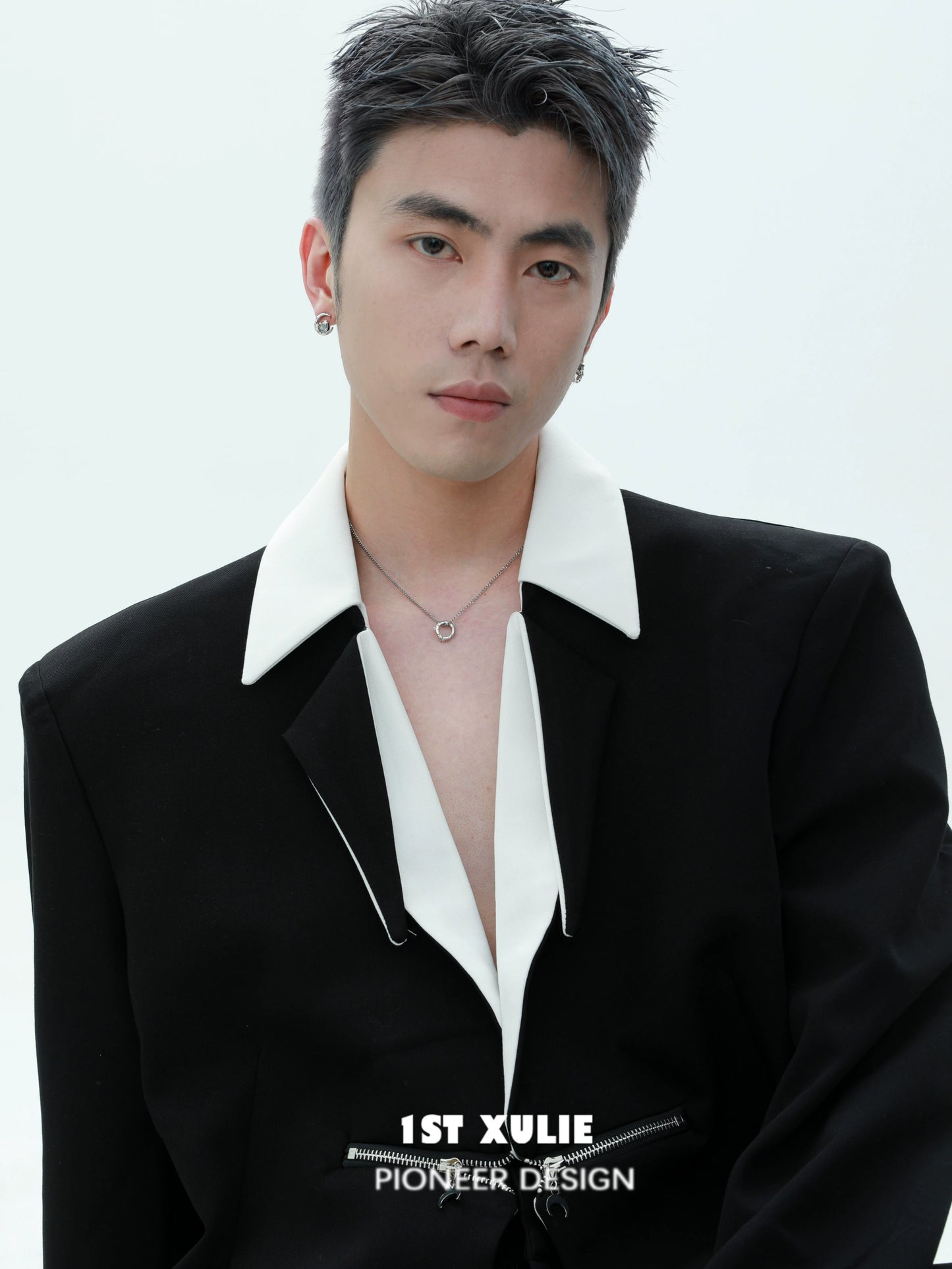 Stylish model wearing a black and white gothic necklace with a modern outfit highlighting unique design