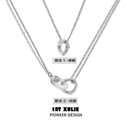 Stylish black and white gothic necklace featuring dual silver chains with unique pendant design