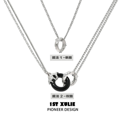 Stylish black and white gothic necklace featuring layered silver chains and unique pendants