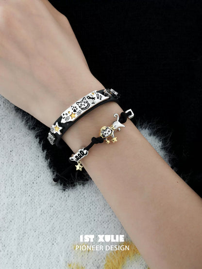 Charming black kitty leather bracelet adorned with playful charms and a stylish design