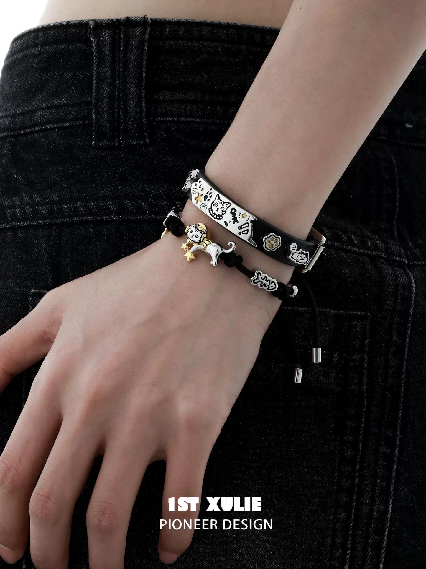 Stylish black kitty leather bracelet stacked with other bracelets for a trendy look