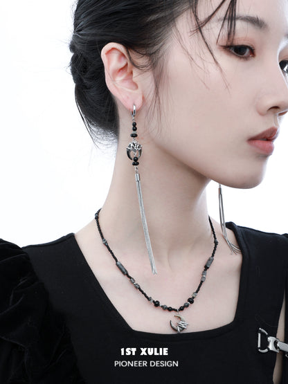 Model wearing a stylish black moon agate necklace with silver accents and complimentary earrings