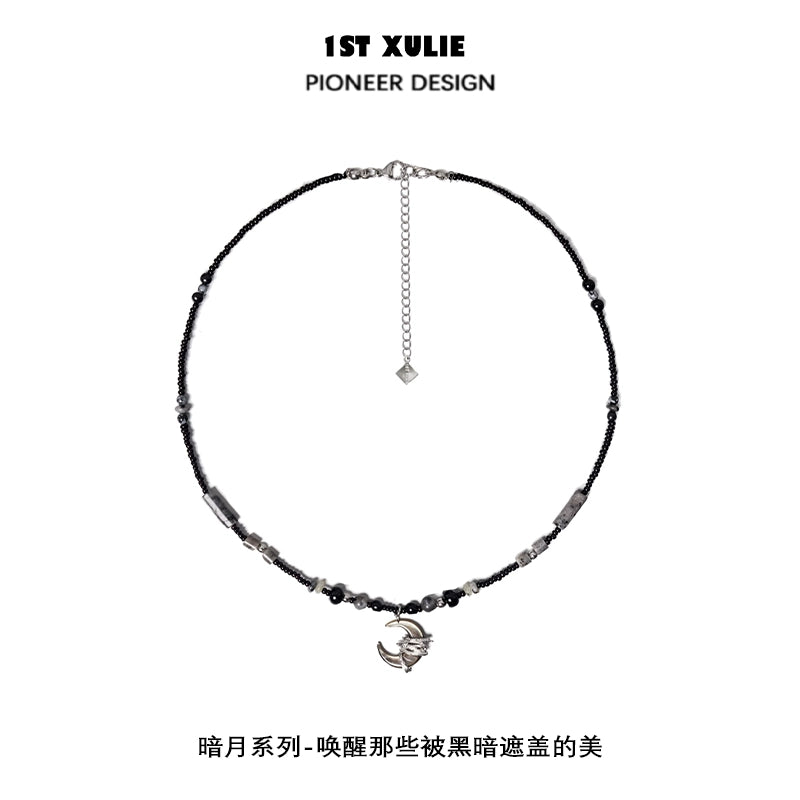 Black moon agate necklace featuring unique beads and a stylish charm for elegant looks