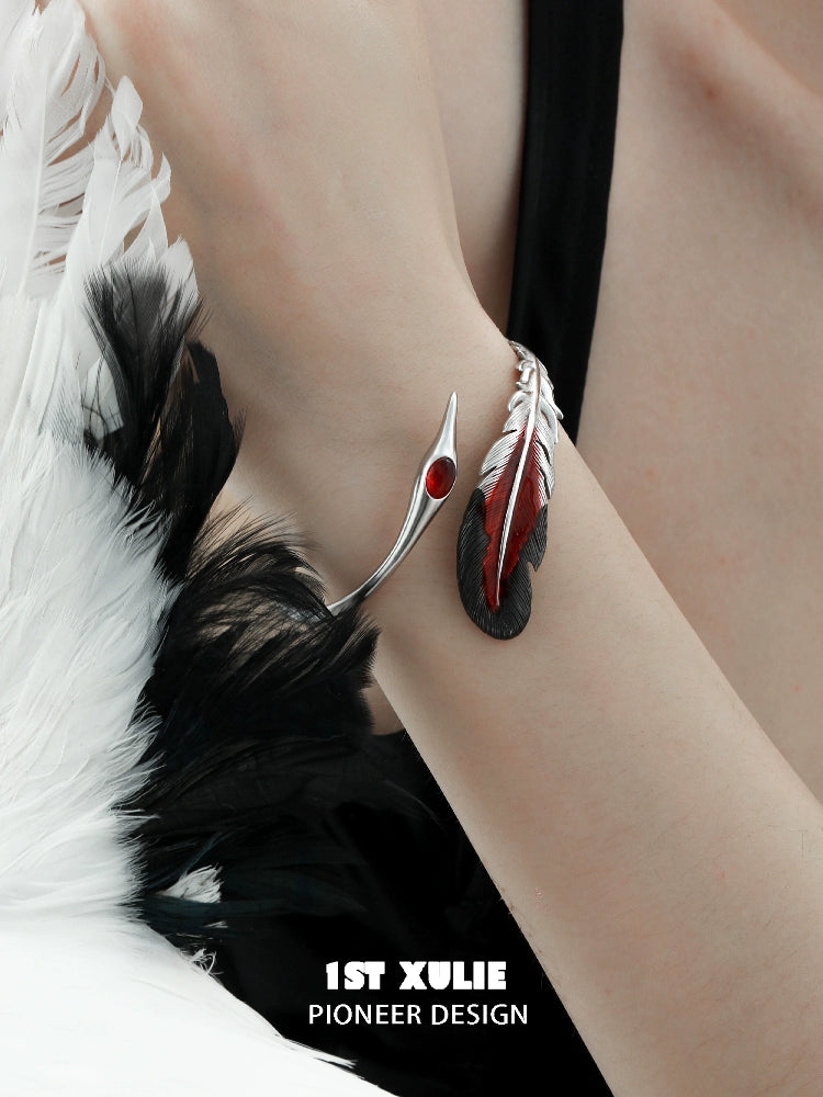 Elegant bloody feather bracelet by 1STXULIE featuring red and black accents on a silver band