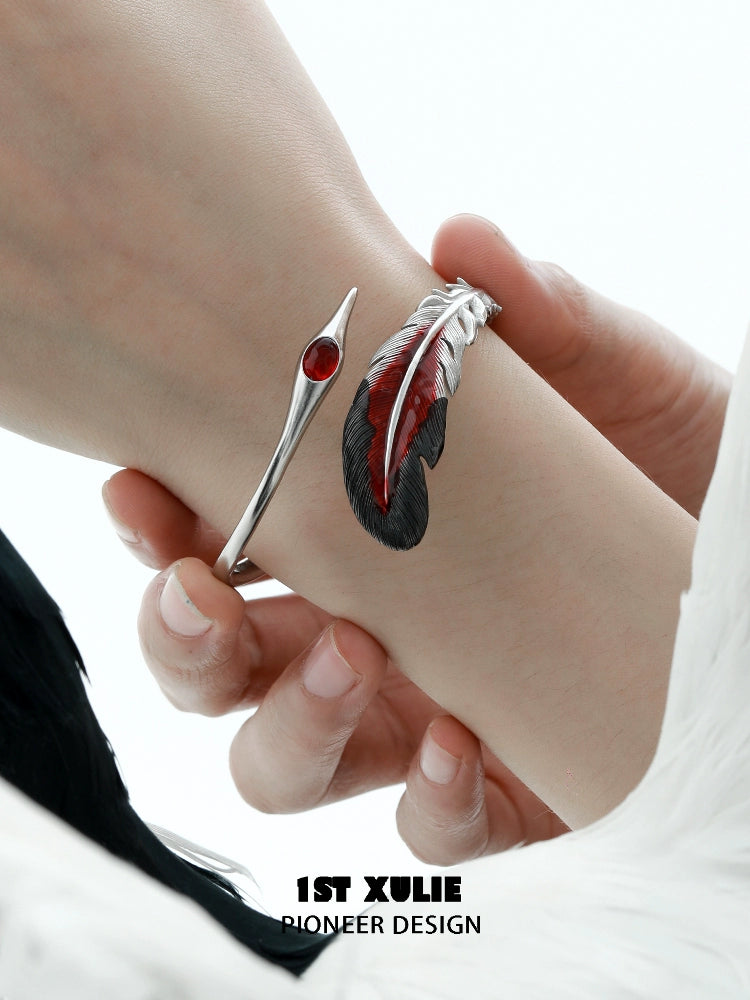 Stylish bloody feather bracelet with red gemstone and sleek metal design for a unique look