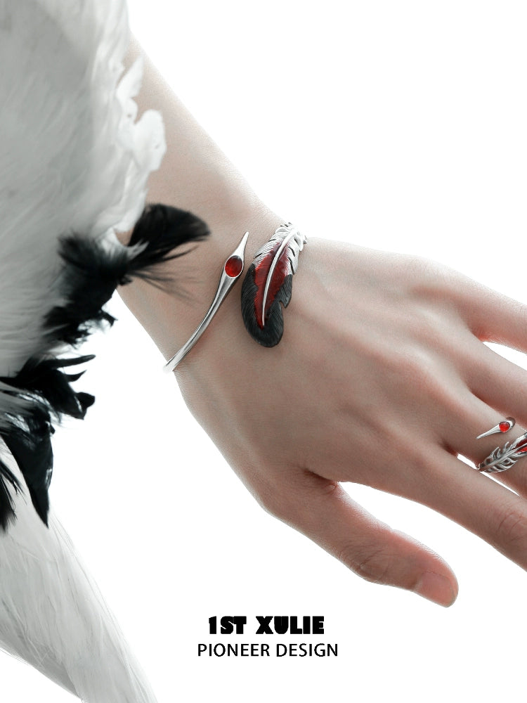 1ST XULIE bloody feather bracelet in silver with red accents, elegantly worn on a hand