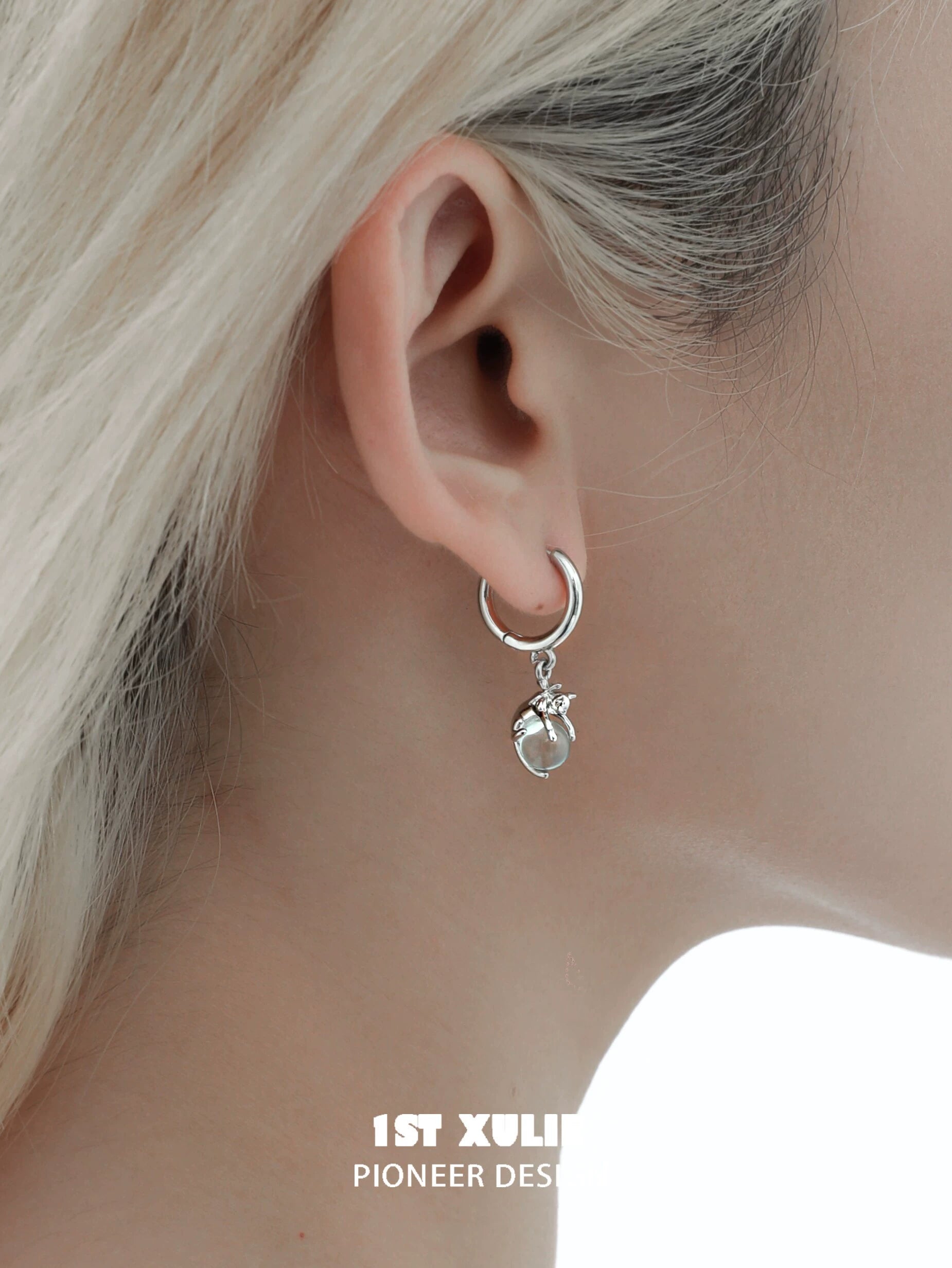 Silver hoop earrings featuring a blue kitten charm, perfect for pet lovers