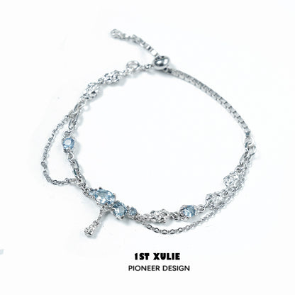 Elegant blue moonstone bracelet with silver chain, featuring multiple shimmering stones
