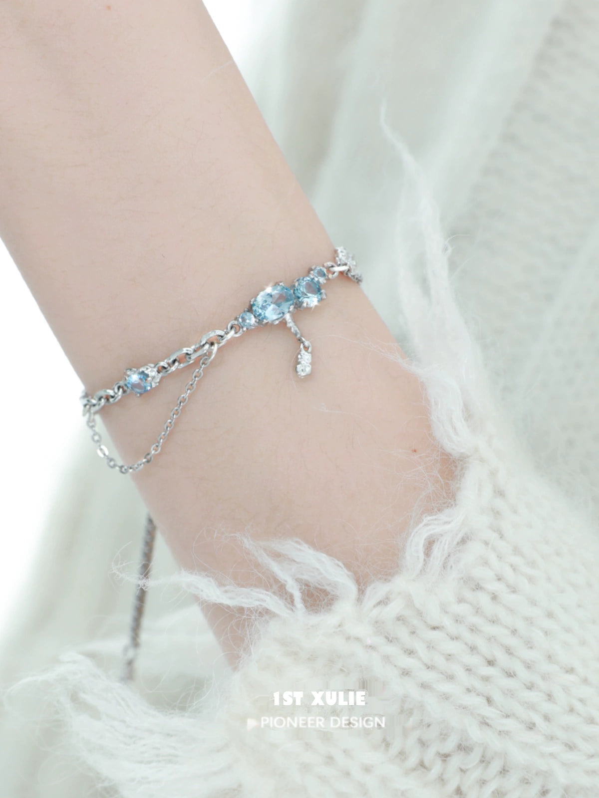 Elegant 1ST XULIE blue moonstone bracelet with silver accents, showcasing shimmering gemstones on a delicate chain