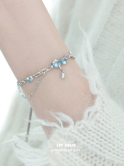 Elegant 1ST XULIE blue moonstone bracelet with silver accents, showcasing shimmering gemstones on a delicate chain