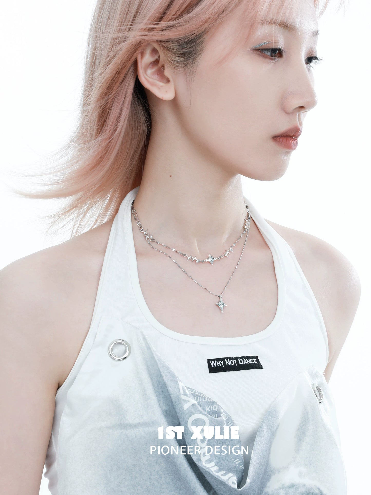 Blue starry sky necklace layered with silver chains, worn elegantly by a model