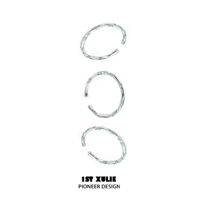 Set of three unique rings featuring a blue textured silver ring design for stylish layering