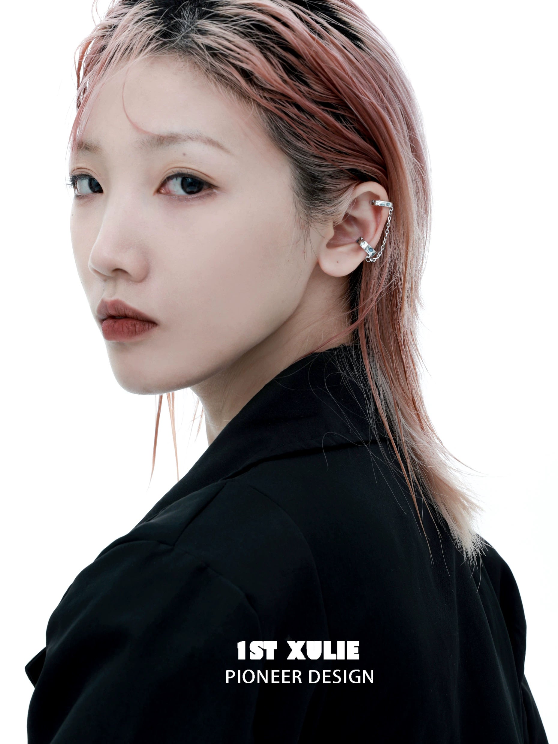 Trendy celestial ear cuff worn by a model with pink hair showcasing modern fashion details