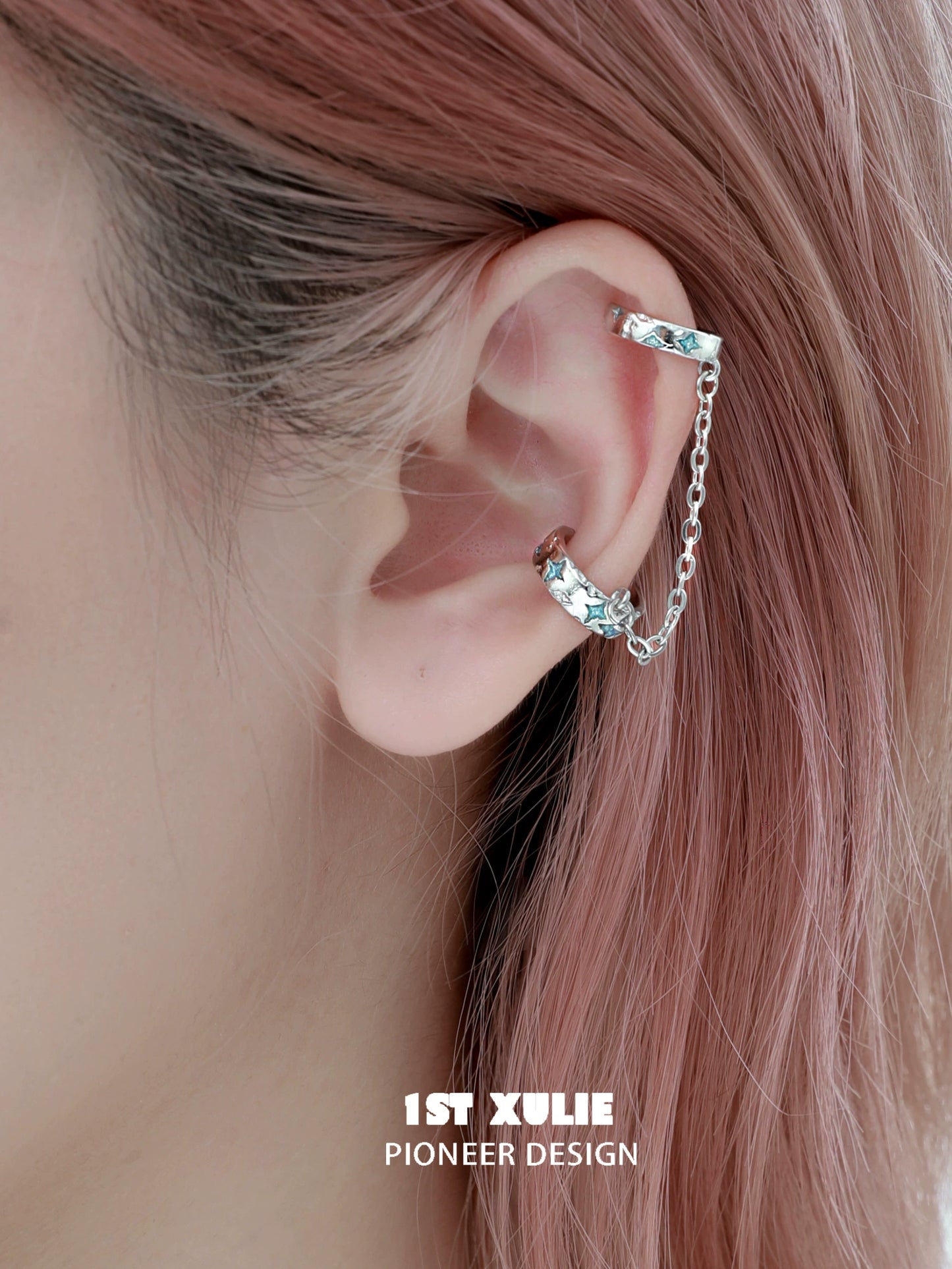 Celestial ear cuff by 1ST XULIE featuring a stylish design with a chain and sparkling accents